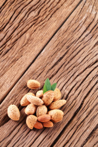 Almond nuts with leaves. Isolated on a white background.