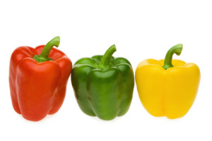 Red, green and yellow pepper on white background, close-up
